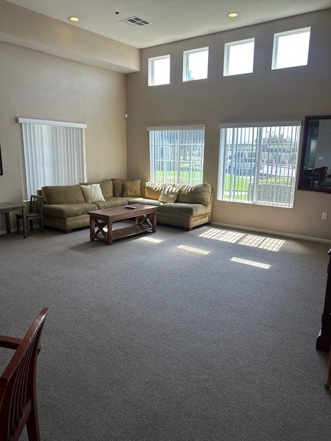 A living room with a couch, chair, and table.