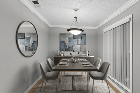 A dining room with a table set for six.