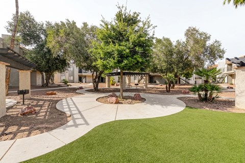 A residential area with a grassy area and trees.