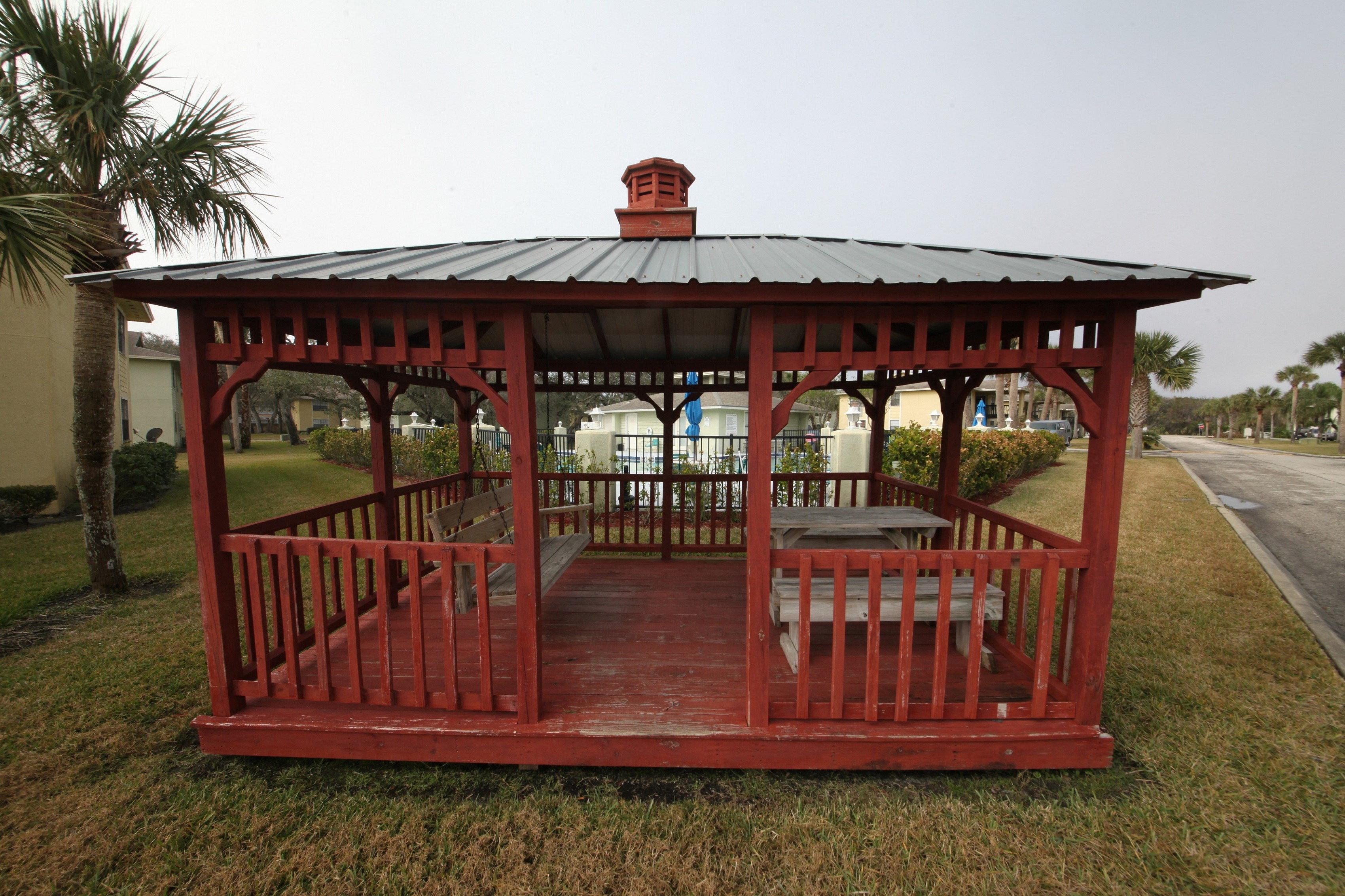 a gazebo with a bench and a table