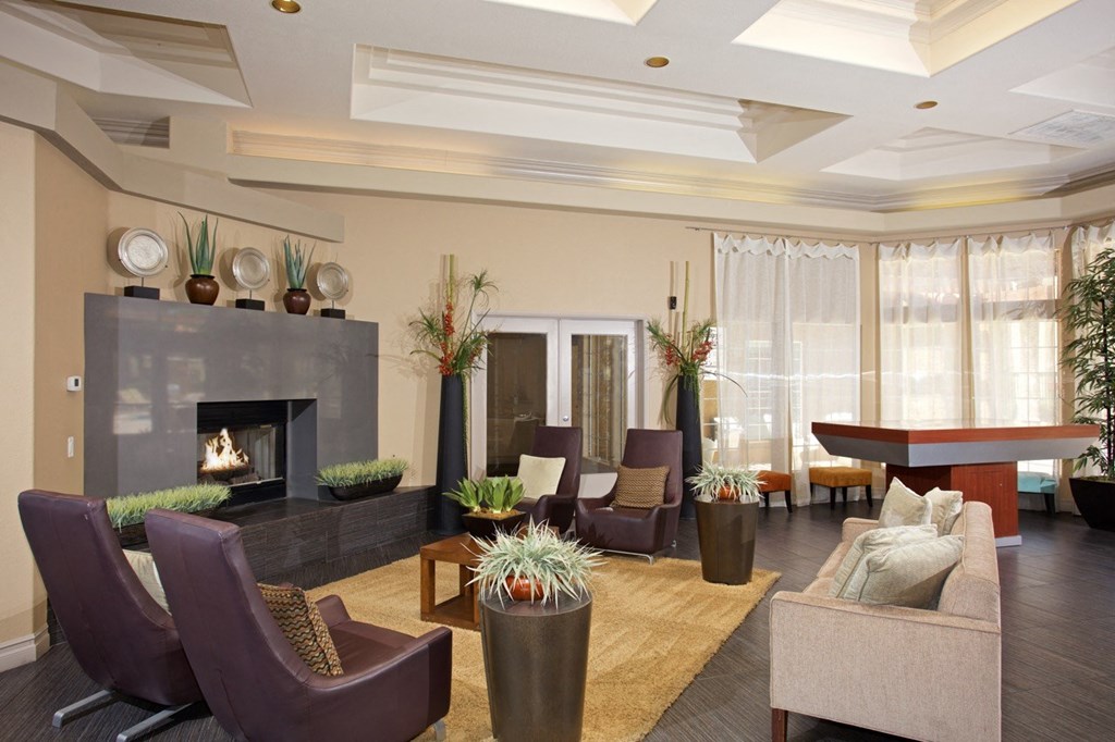 a living room with a fireplace and chairs