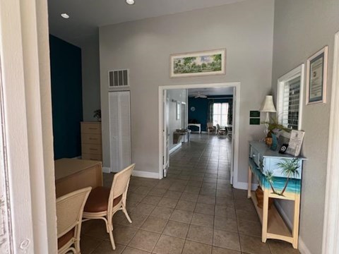 A living room with a dining table and chairs.