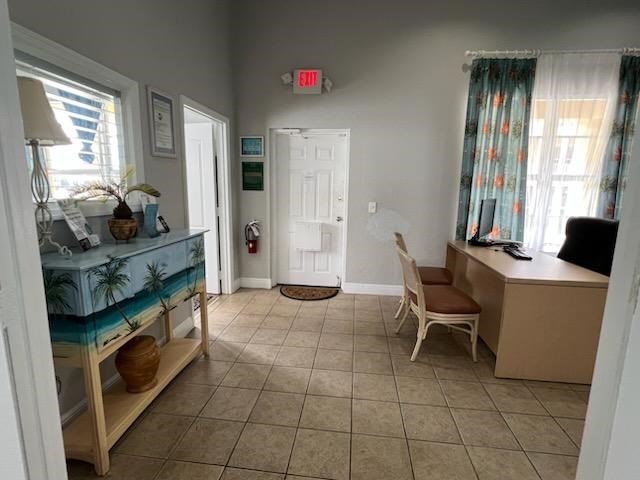 A room with a bed, desk, and chair.