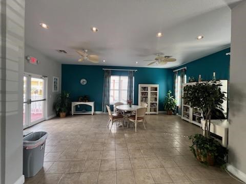 A spacious room with a dining table and chairs.