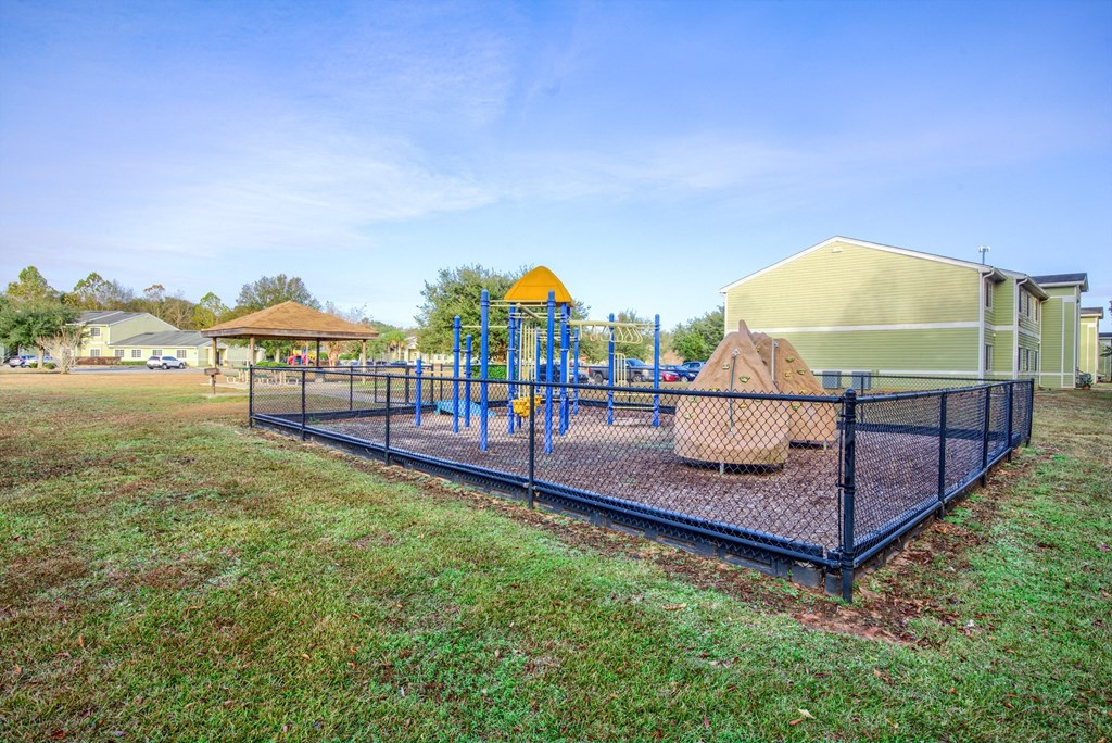 A playground with a blue swing set and a yellow slide.