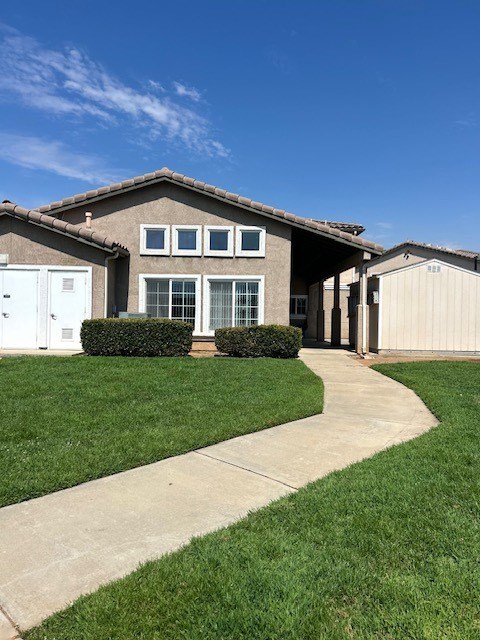 A house with a white garage door and a brown roof.