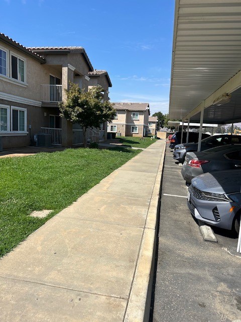 A row of houses with cars parked on the street.