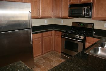 Kitchen with wooden cabinets at Carlisle at Summerlin, Las Vegas
