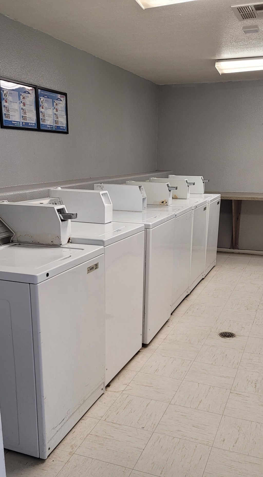 A row of washing machines in a laundromat.