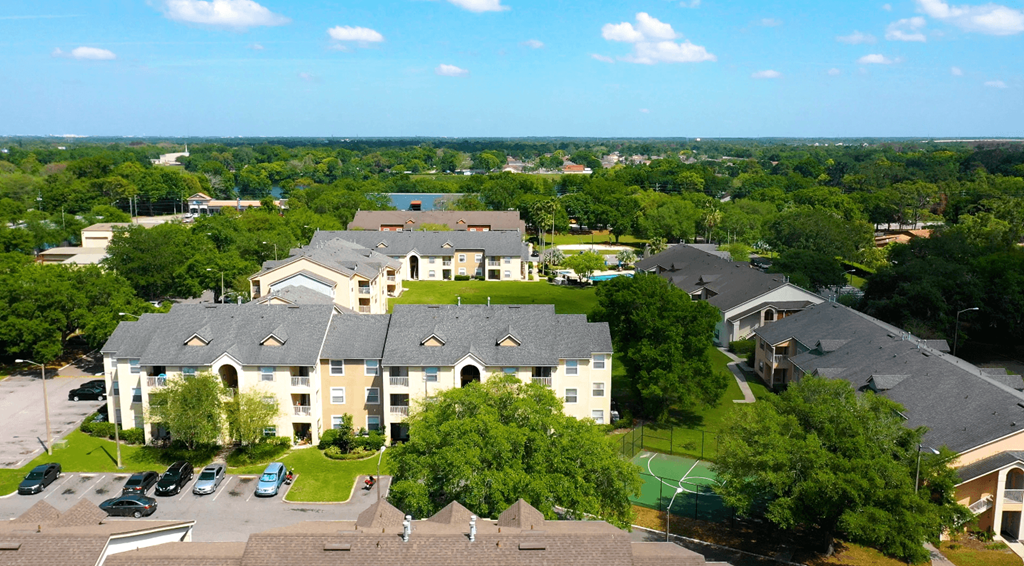 A large building with a green lawn in front.