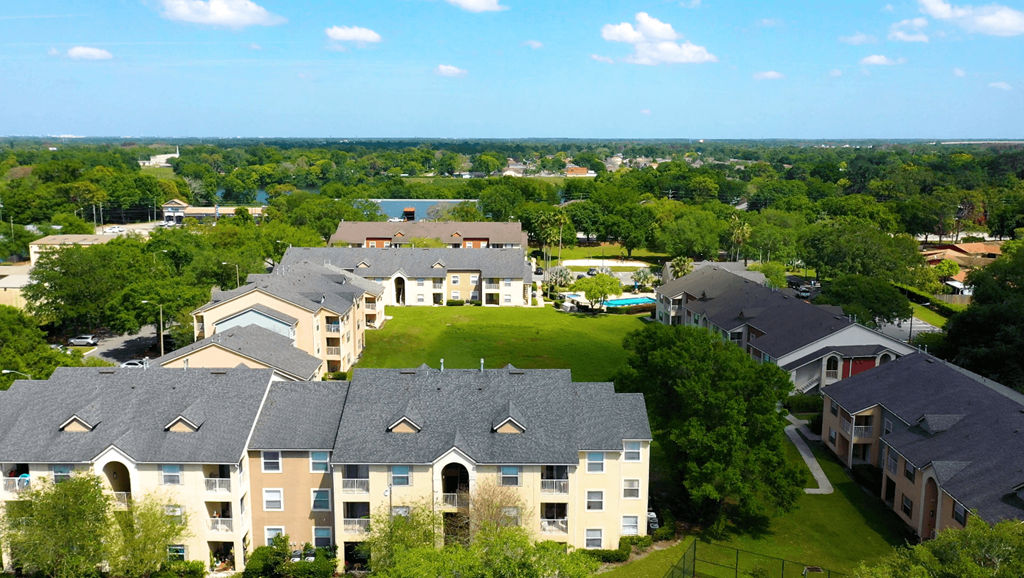 A large apartment complex with multiple buildings and green lawns.