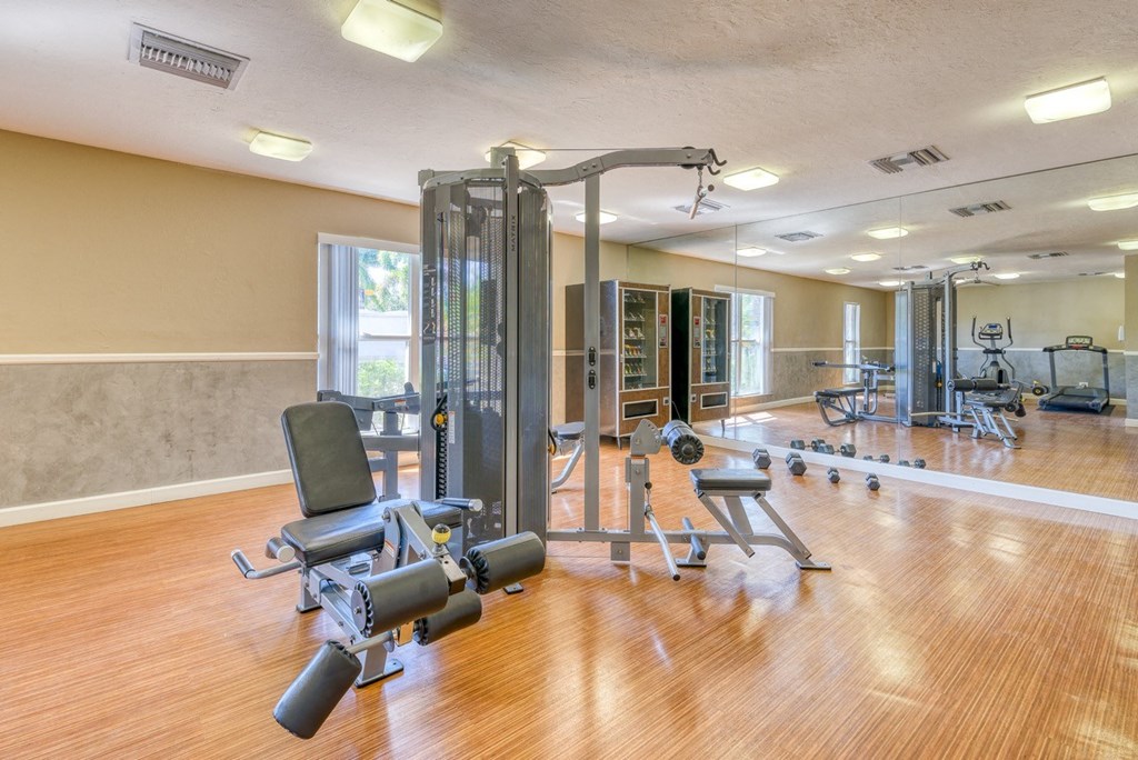 A gym with a variety of equipment including a leg press machine.