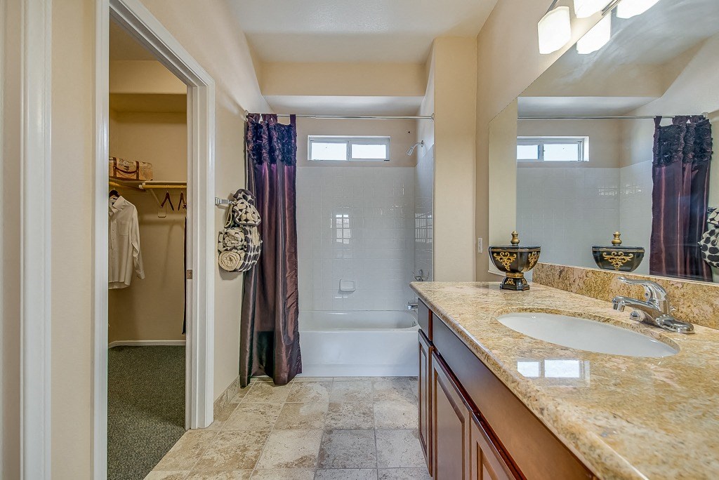a bathroom with a shower and a sink and a mirror