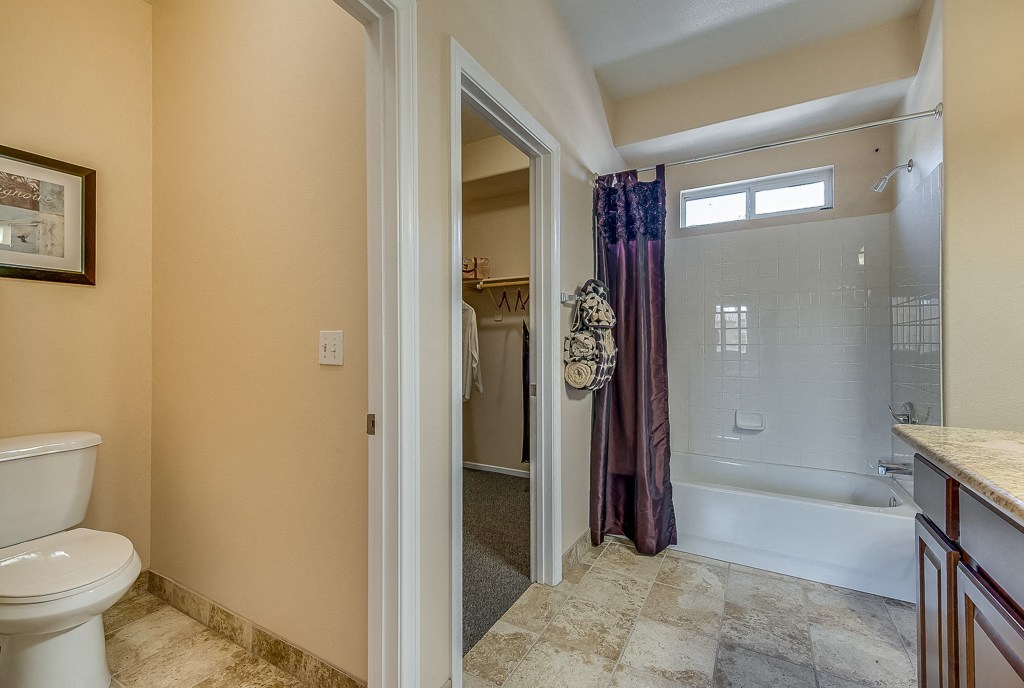 a bathroom with a shower and a toilet and a sink