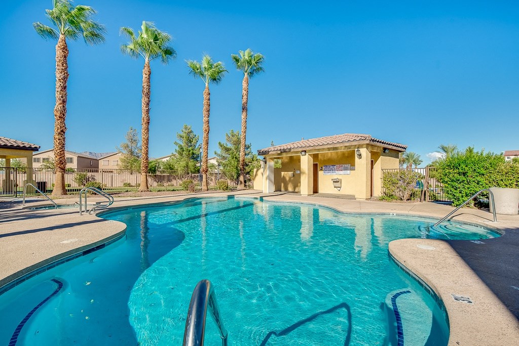 the swimming pool at the resort with palm trees