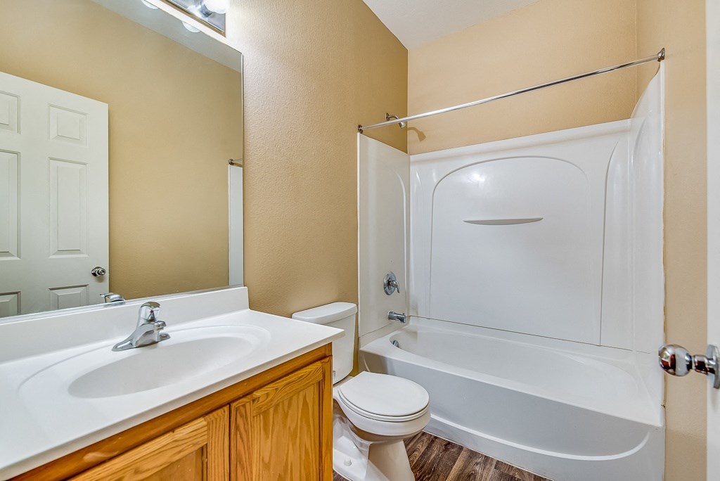 a bathroom with a sink toilet and shower and a tub