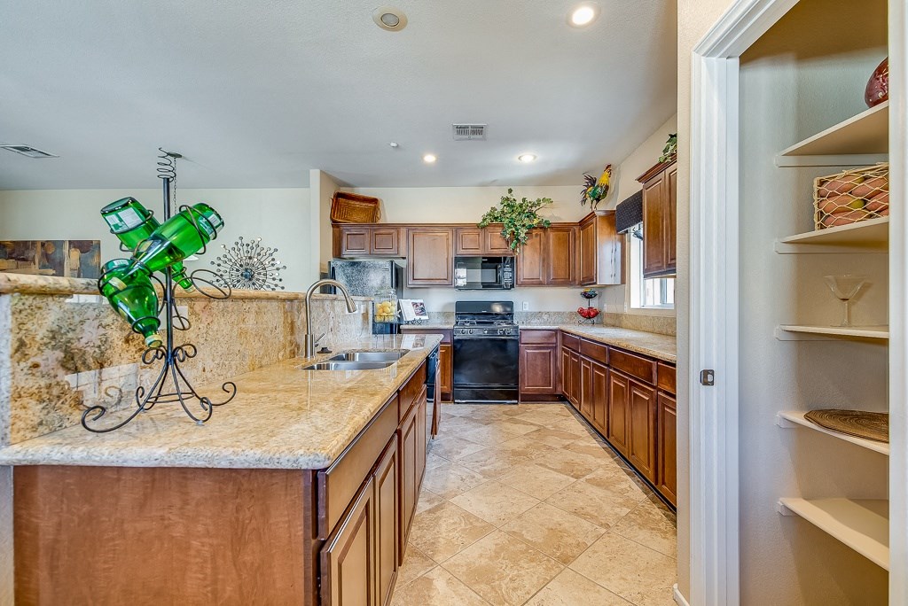 a kitchen with wooden cabinets and granite counter tops