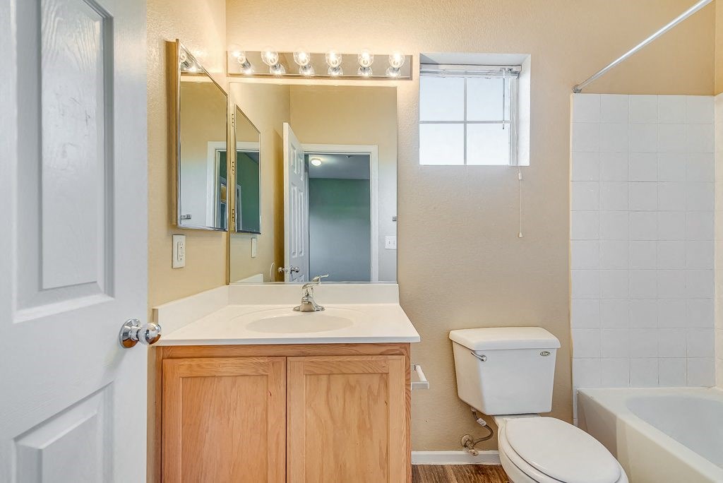 a bathroom with a sink toilet and a mirror
