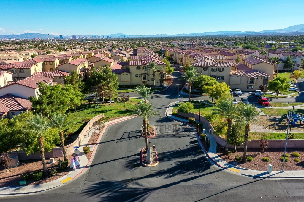 an aerial view of a neighborhood with houses and palm trees