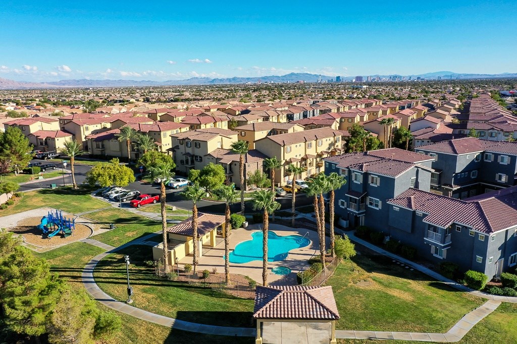 an aerial view of a neighborhood with houses and a swimming pool