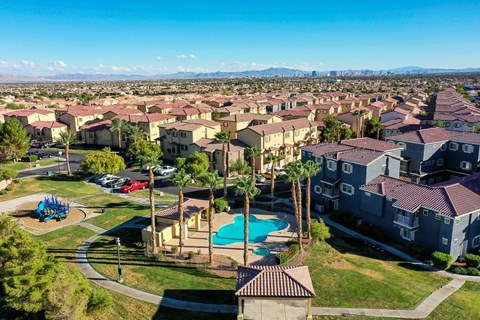 an aerial view of a neighborhood with houses and a swimming pool