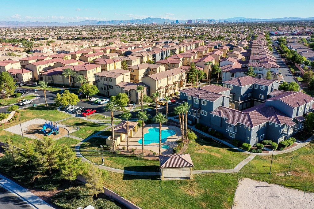 an aerial view of a neighborhood with houses and a swimming pool