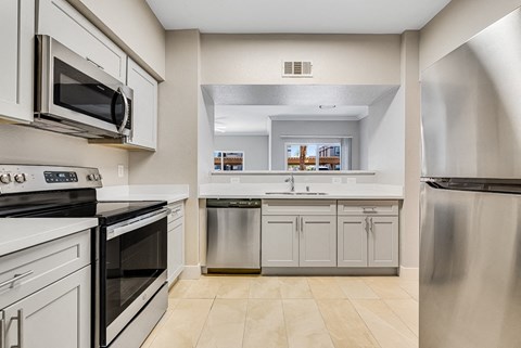 a kitchen with stainless steel appliances and white cabinets