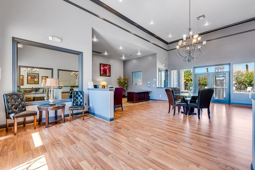 a living room and dining room with a table and chairs