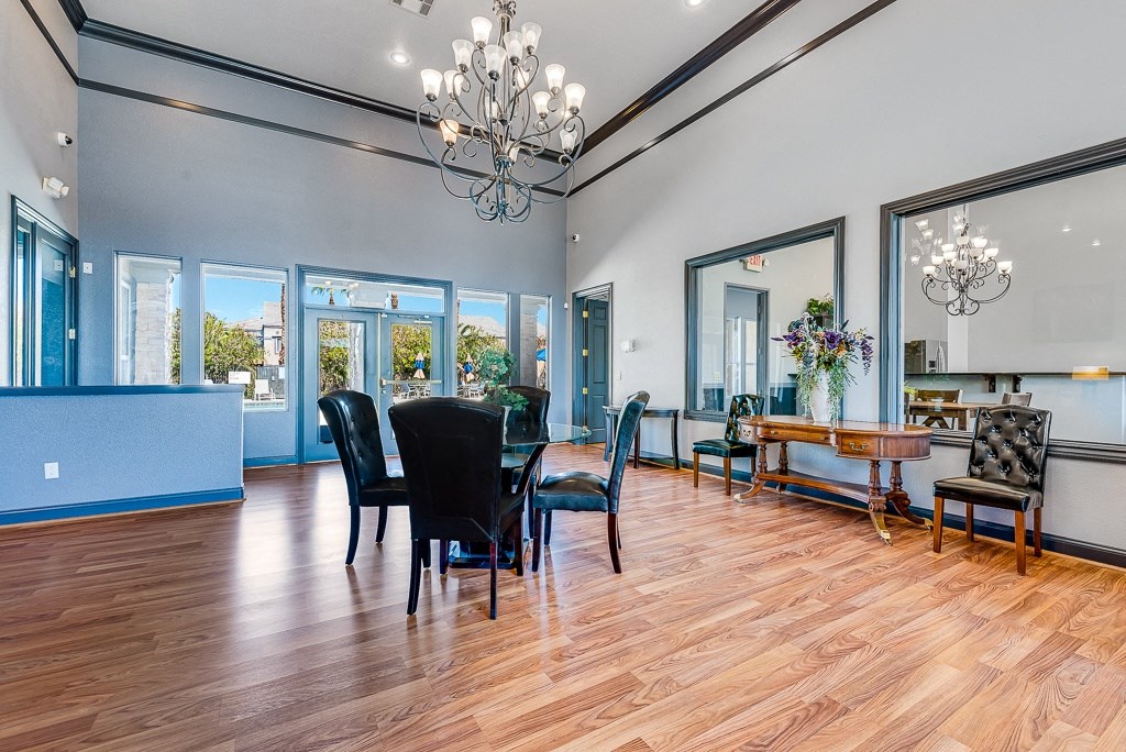 a dining room with a table and chairs and a chandelier