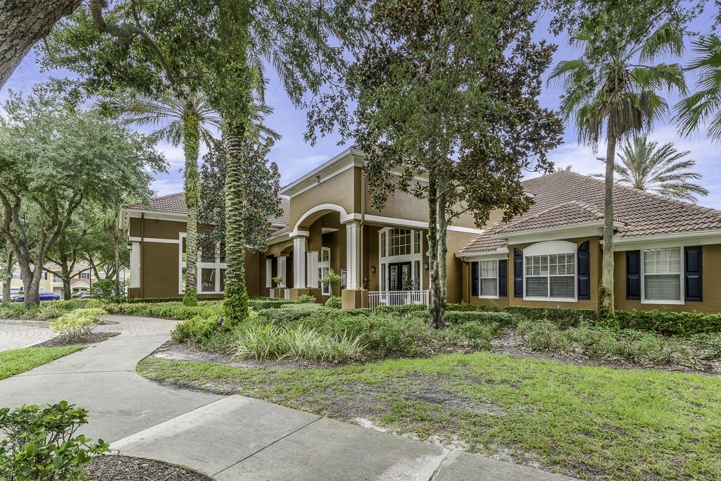 A row of houses with trees in front.