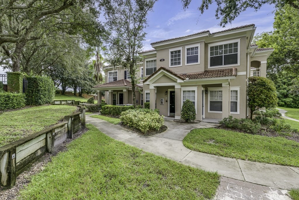 A large house with a driveway and a fence.