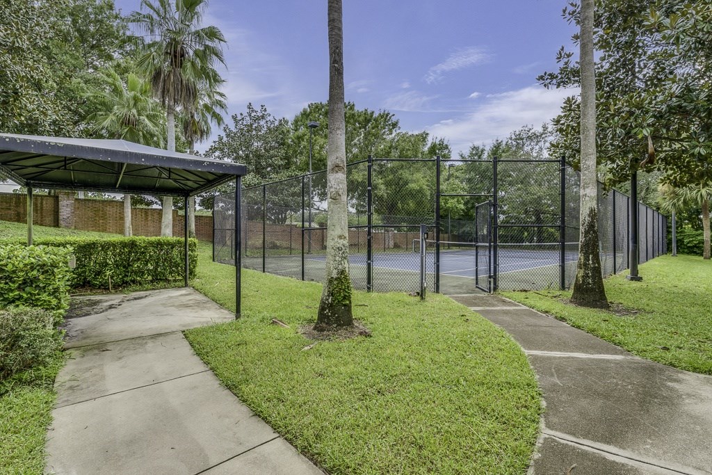 A park with a fence and a building.