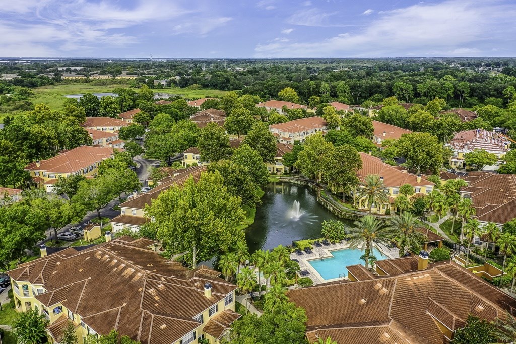 A bird's eye view of a resort with a pool and a fountain.