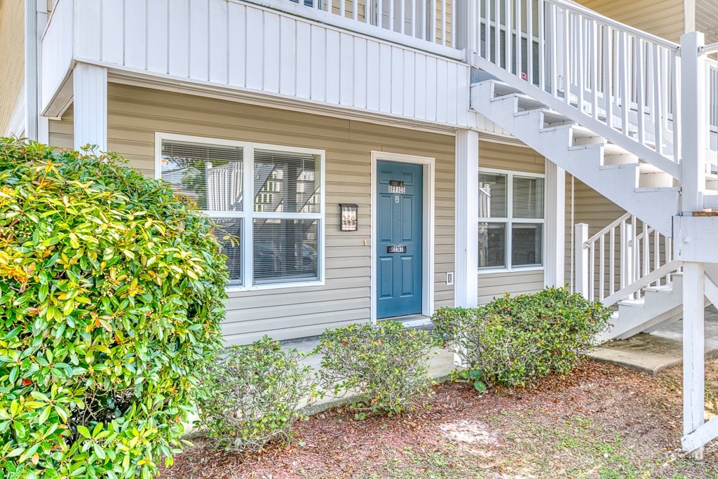 A house with a blue door and a white staircase.