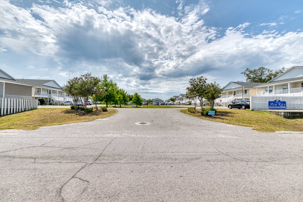 A residential area with houses and a paved road.