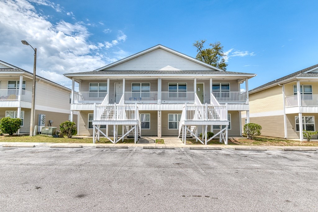 A row of houses with a clear blue sky above them.