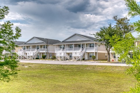A large building with a grey roof and white railings.