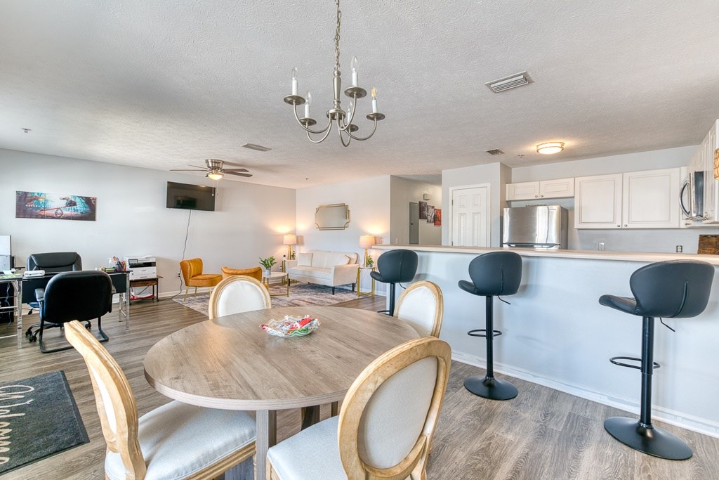 A dining room with a round table and chairs.