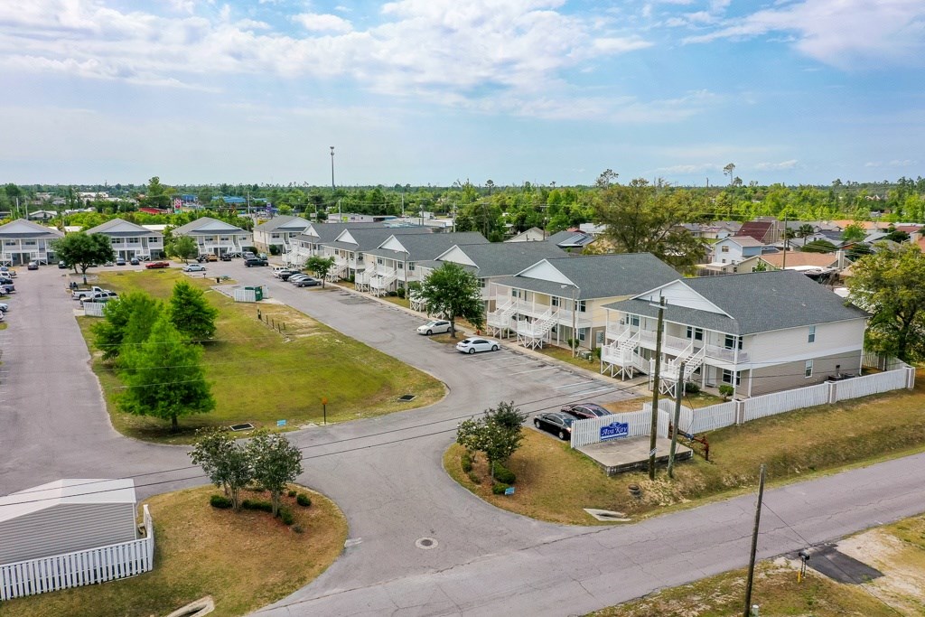 A residential area with houses and a parking lot.