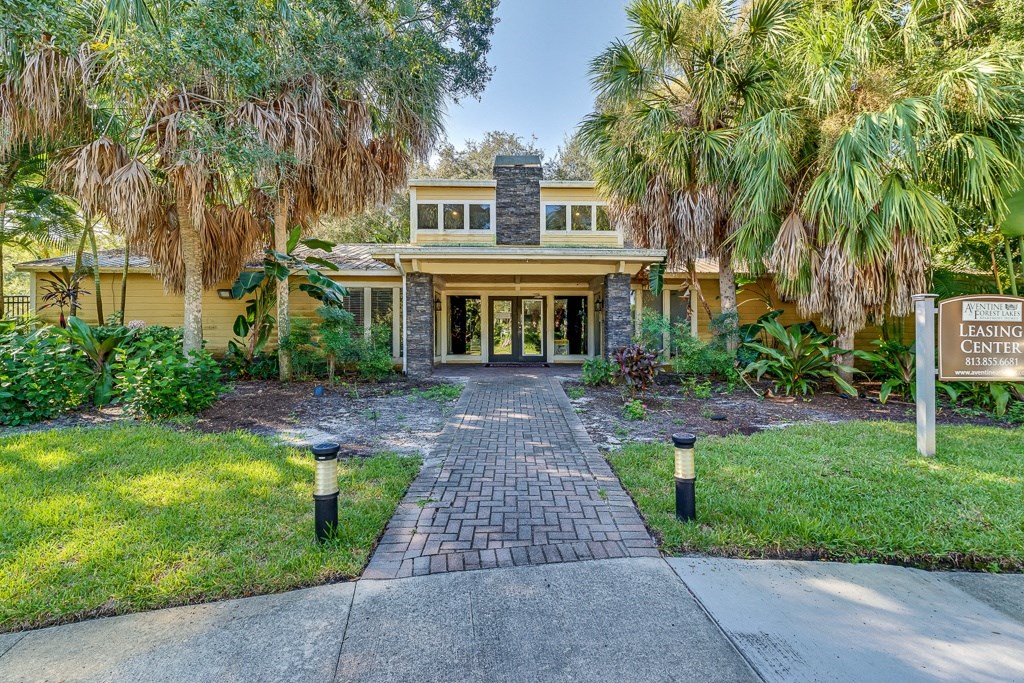 a house with palm trees in front of it