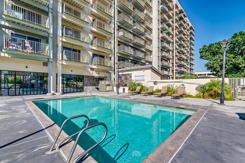 A swimming pool in front of a residential building.
