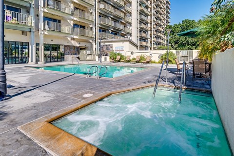 a swimming pool with a building in the background