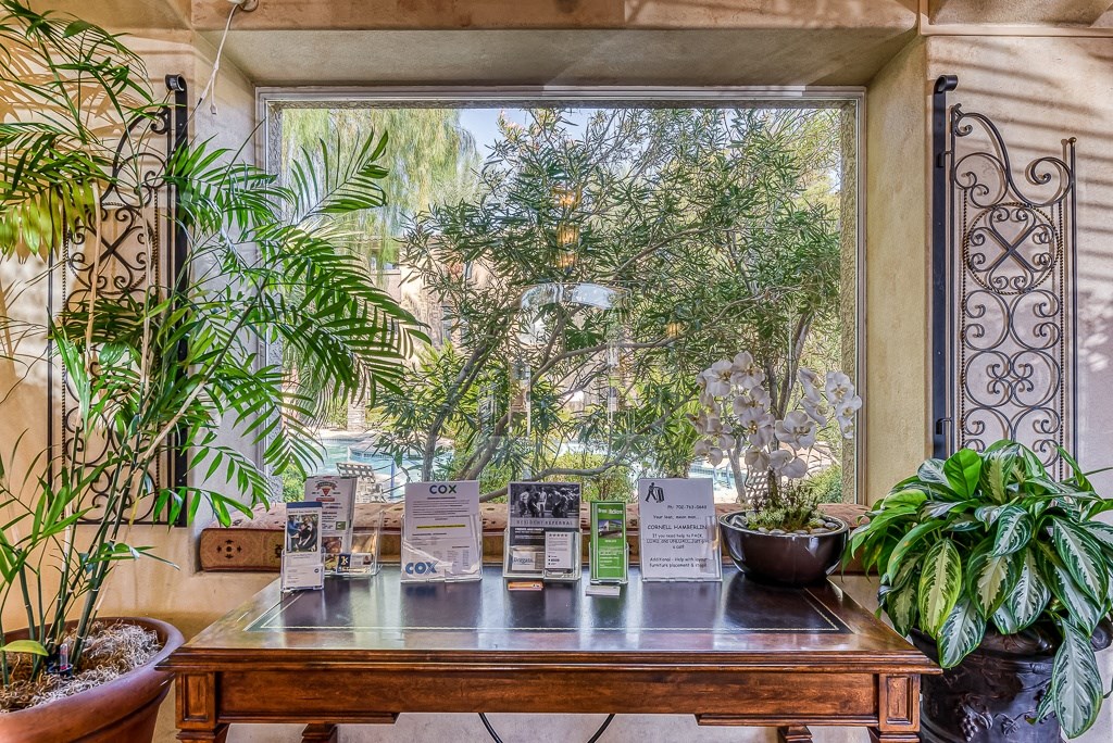 a table with plants in front of a window