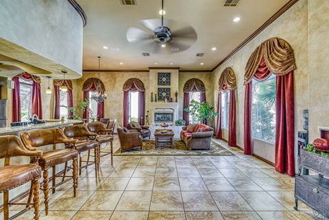 a large living room with a bar and a fireplace