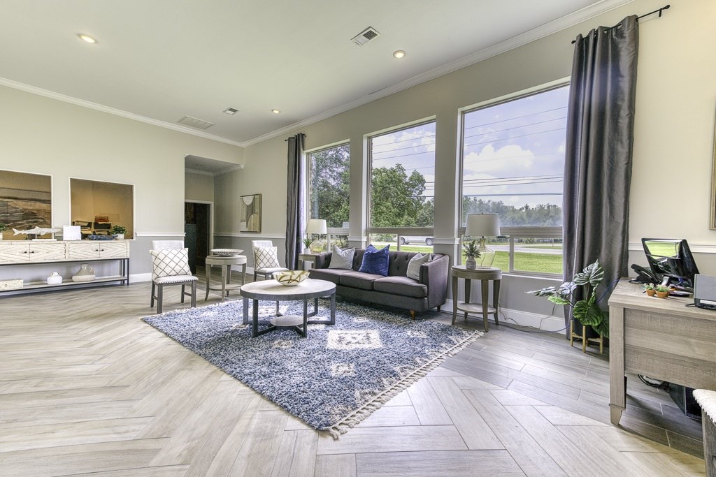 A spacious living room with a large window overlooking a green landscape.