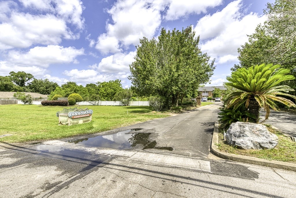A street view of a residential area with a sign that reads "Bakery".
