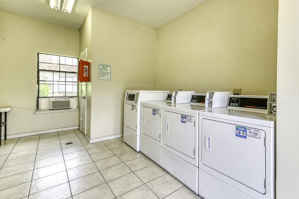 A laundry room with washers and dryers.
