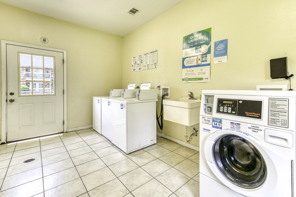 A laundry room with a washer and dryer, a washing machine, and a washing machine.