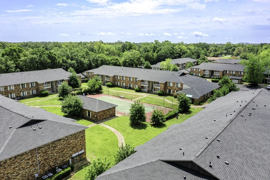 A view of a residential area with houses and trees.