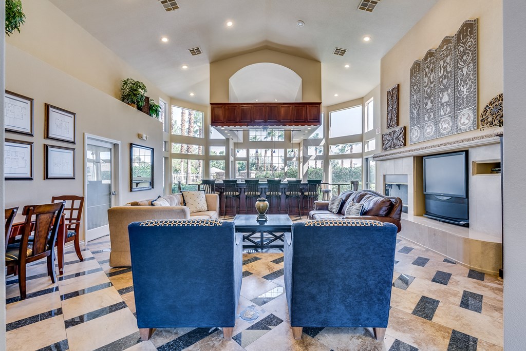 a large living room with a large table and chairs and a television